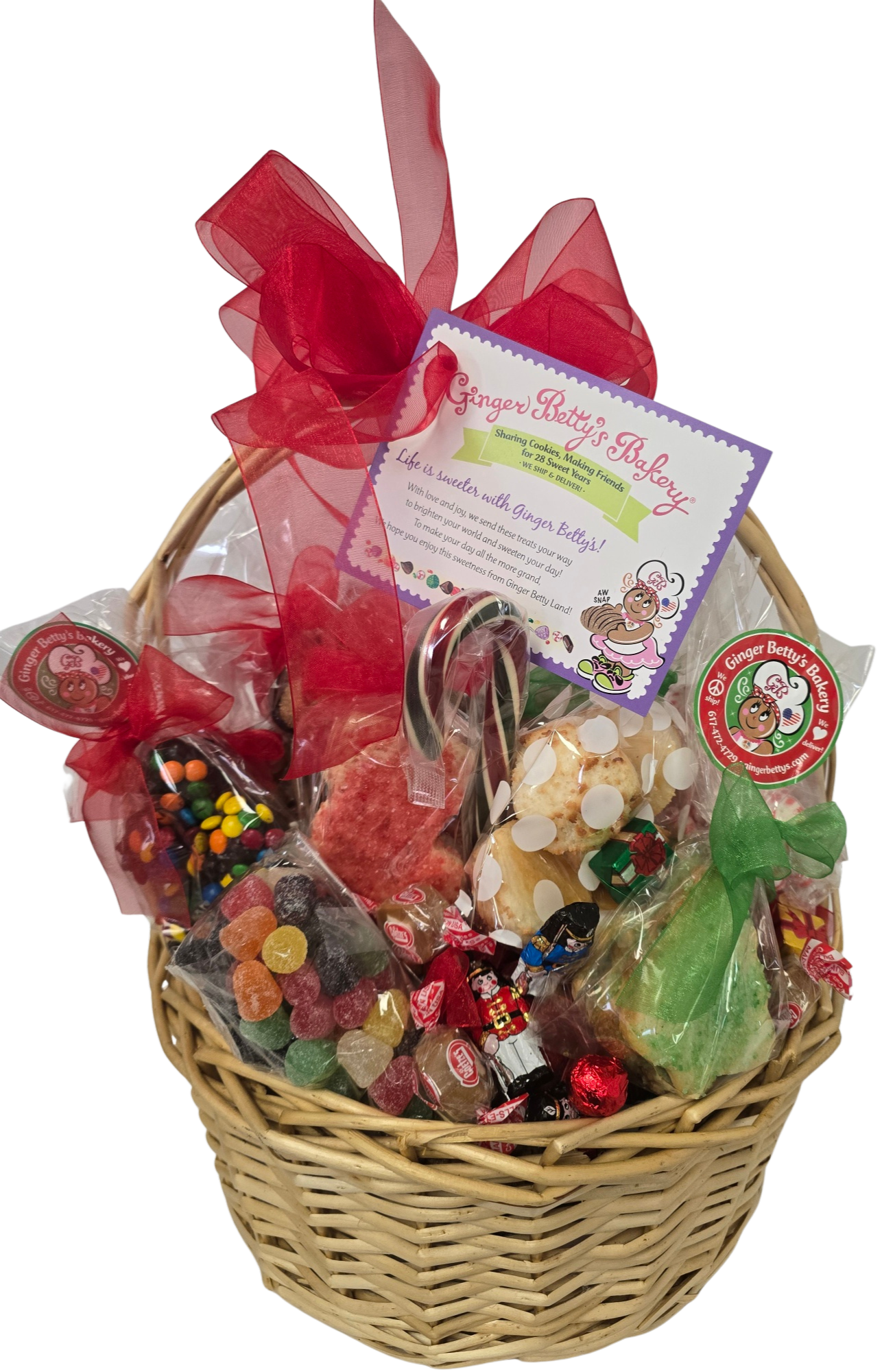 Wicker gift basket filled with colorful candies and a red ribbon on a white background