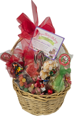 Wicker gift basket filled with colorful candies and a red ribbon on a white background