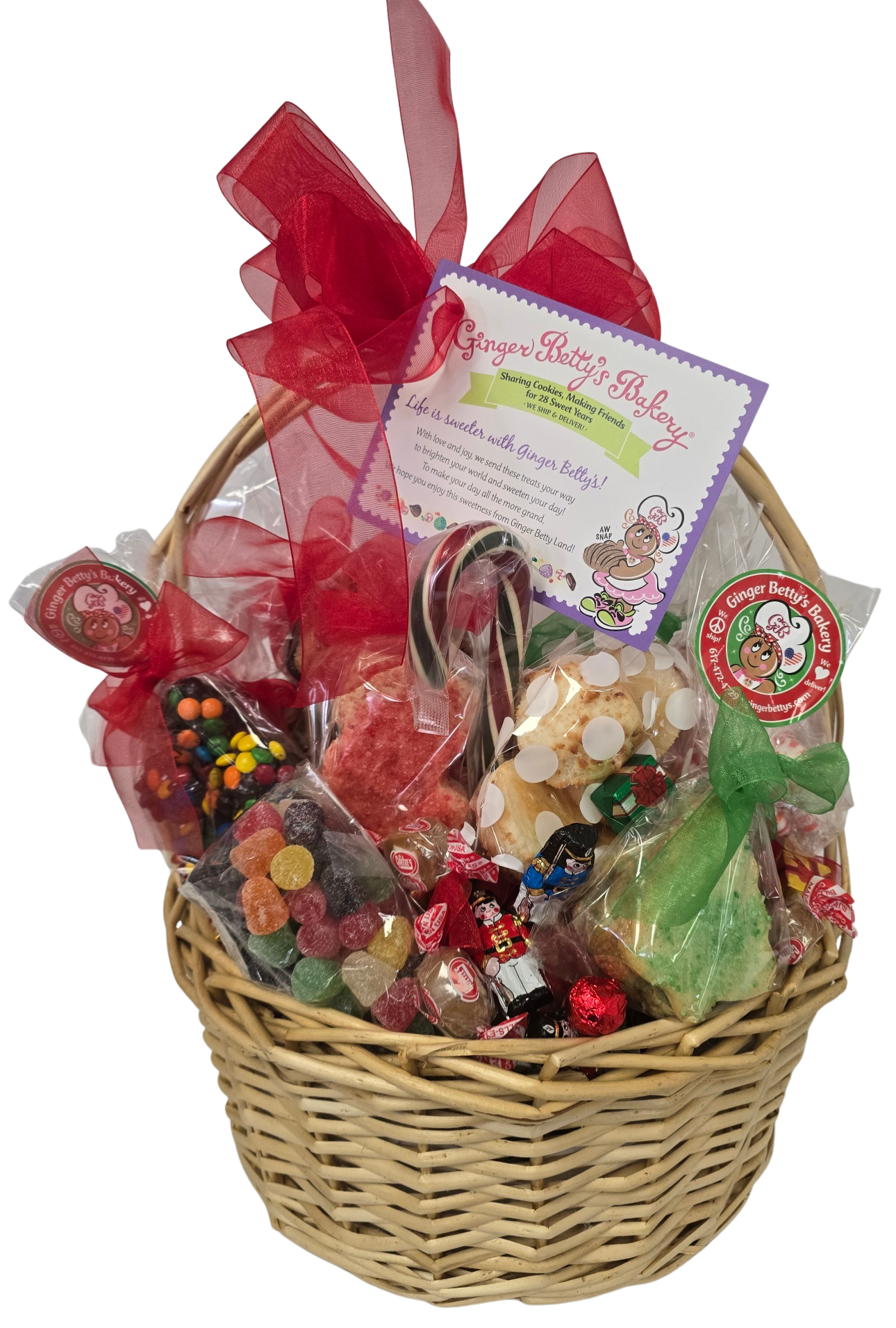 Gourmet gift basket with candies and a red bow on a white background